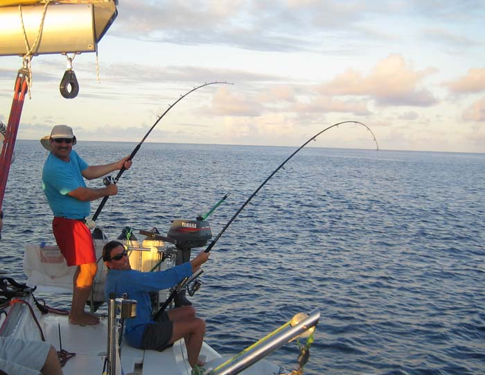 Steve and one of the other lads being played by yellowfin tuna. Note the spinning rod and fixed spool reel.