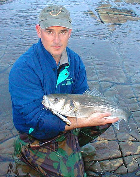 The fish took the popper over rocks in a heavy surf.
