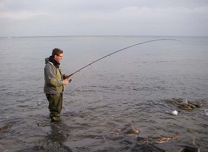 Ben carefully guides his fish through the rocks.