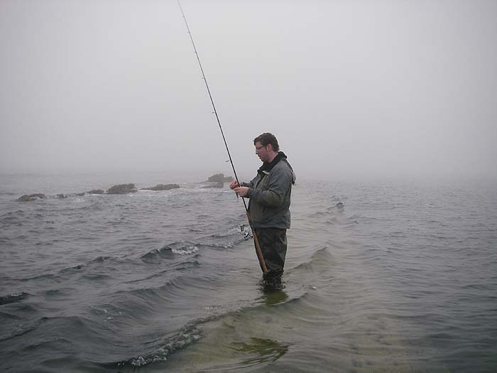 Ben pauses to clear a bit of weed off the lure. My fish was hooked on the other side of the rocks that are sticking up.