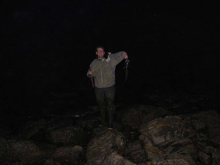 Ben walks ashore with his fish firmly hooked on the plug.