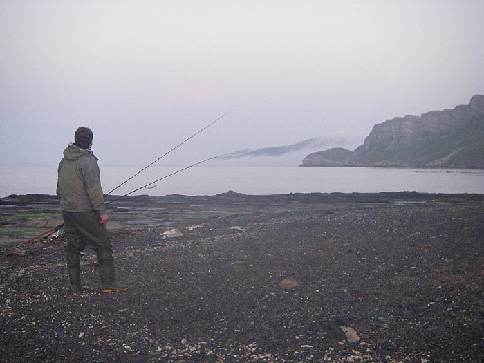 Ben (note both fly and spinning rods) contemplates the mist pouring over the cliffs at Worbarrow. If there was any action he'd be fishing.