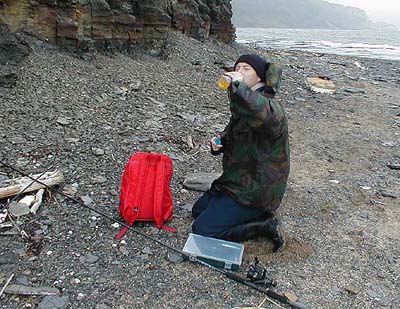 Mark takes a well earned drink after fighting the waves and wind.