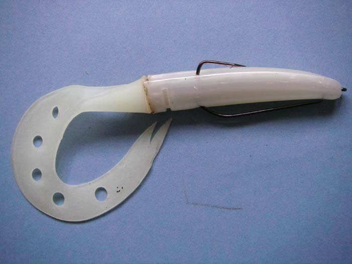 A fish has bitten the lure revealing the point and hopefully hooking itself.