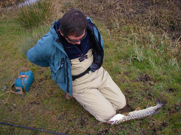 Steve Pitts prepares to unhook a pike.