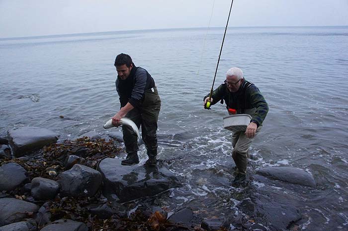 Rob carries Nigel's fish ashore. It doesn't look thin to me.