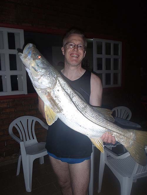 That's what I call a snook. Wonderful sport and popular food fish in Brazil. No wonder he looks pleased.