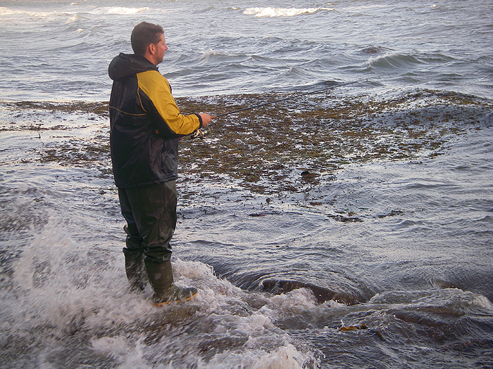 My pal Ben giving it a go with a lure despite the rough water and weed.