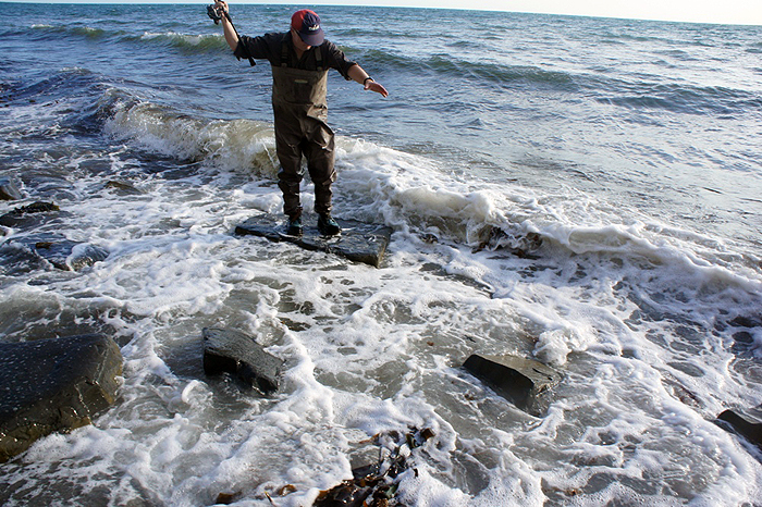 Nigel reaches for the line as the fish slides into the surf.