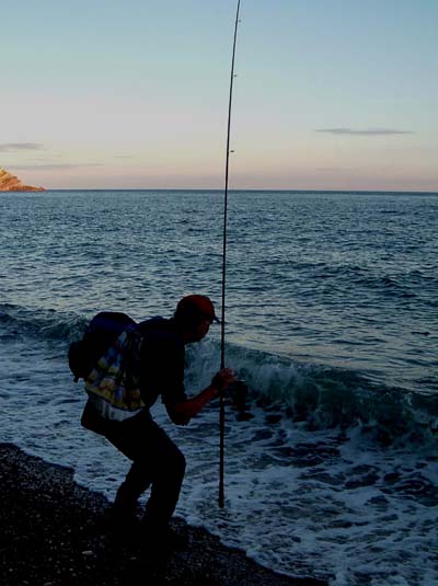 It's pretty gloomy as Nigel prepares to land his mackerel.