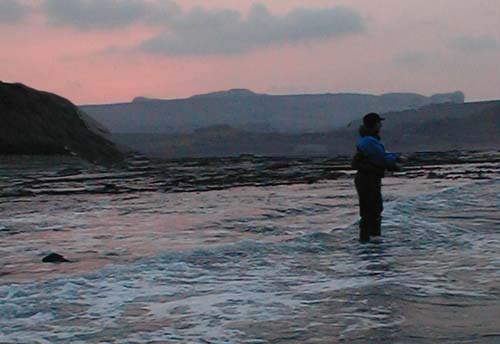 Casting into the teeth of the wind as the sky glows red.