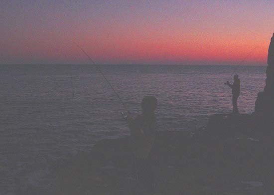 Jamie spinning and his Dad using fly tackle - still pretty dark.