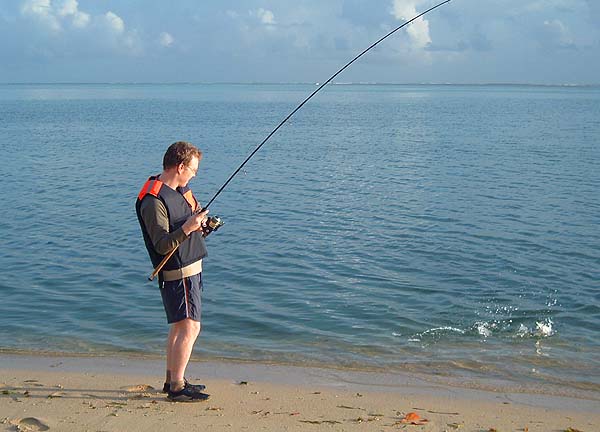 Rich is into a small barracuda. Note the buoyancy vest - an insurance against deep holes encountered when wading.