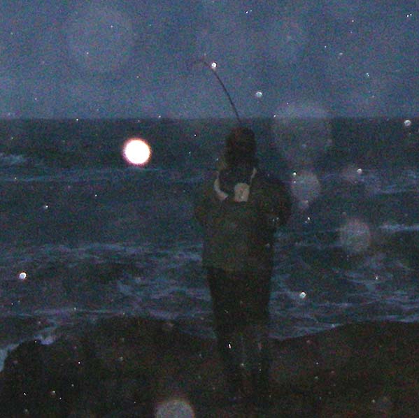 The bass has grabbed Ben's plug and makes off out to sea with the rod arched over.