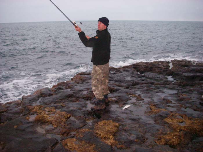 Mark Wills casts his lure with the bass just caught waiting for me to grab the camera.