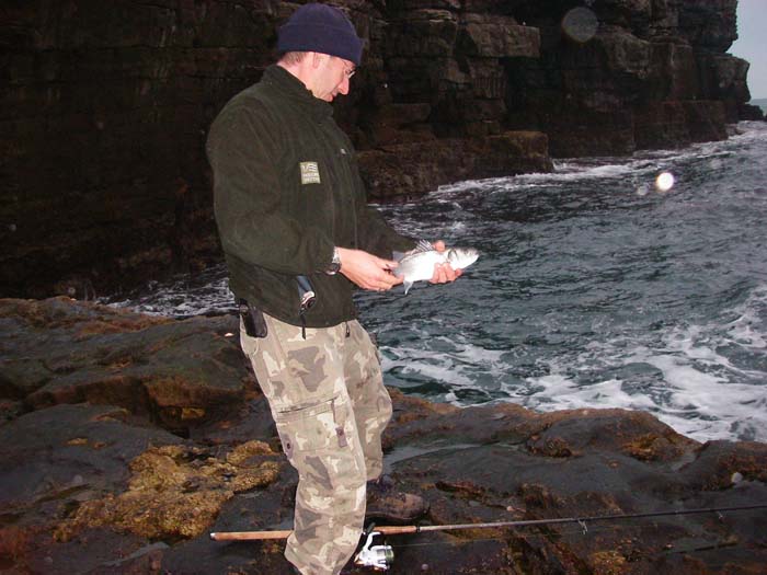 Mark about to return his fish to the water.