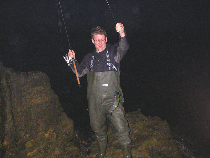 It's still pretty gloomy as Ben swings his mackerel ashore.