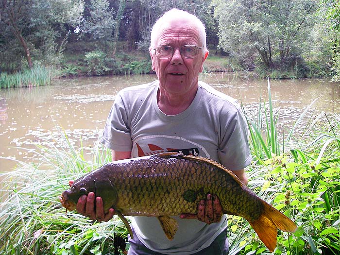 Jamie was kind enough to take this picture.  I haven't got black spots - the carp's tail splashed a lot of mud as it was picked up.