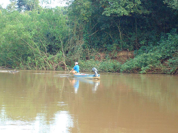 A local pacu angler using a bamboo rod and bread paste bait.