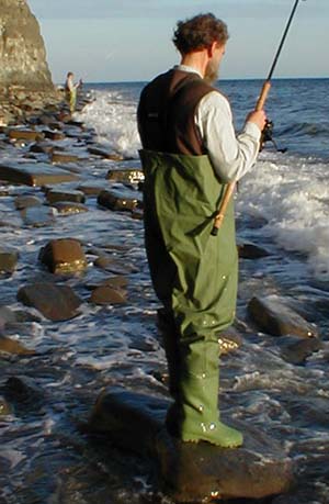 The water glistening on the waders shows how wet you could get even on a calm day like this.  The cleats are fine on wet rocks unless the latter are coated with an invisible film of algae.  Test every foothold.