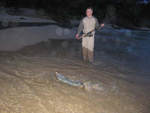 Richard about to lift my first jack from the sea - for Heaven's sake pick it up!. Note the failing light.