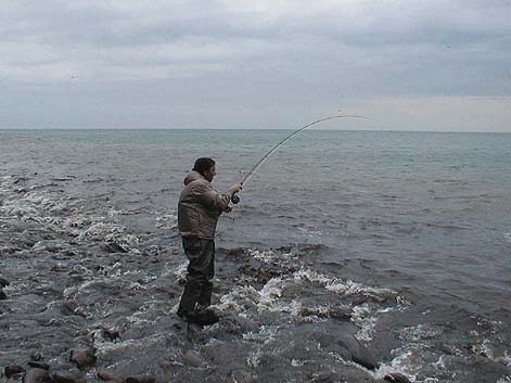 Dressed to stay dry.  In these conditions the undertow rolls the boulders and tends to take your feet from under you.